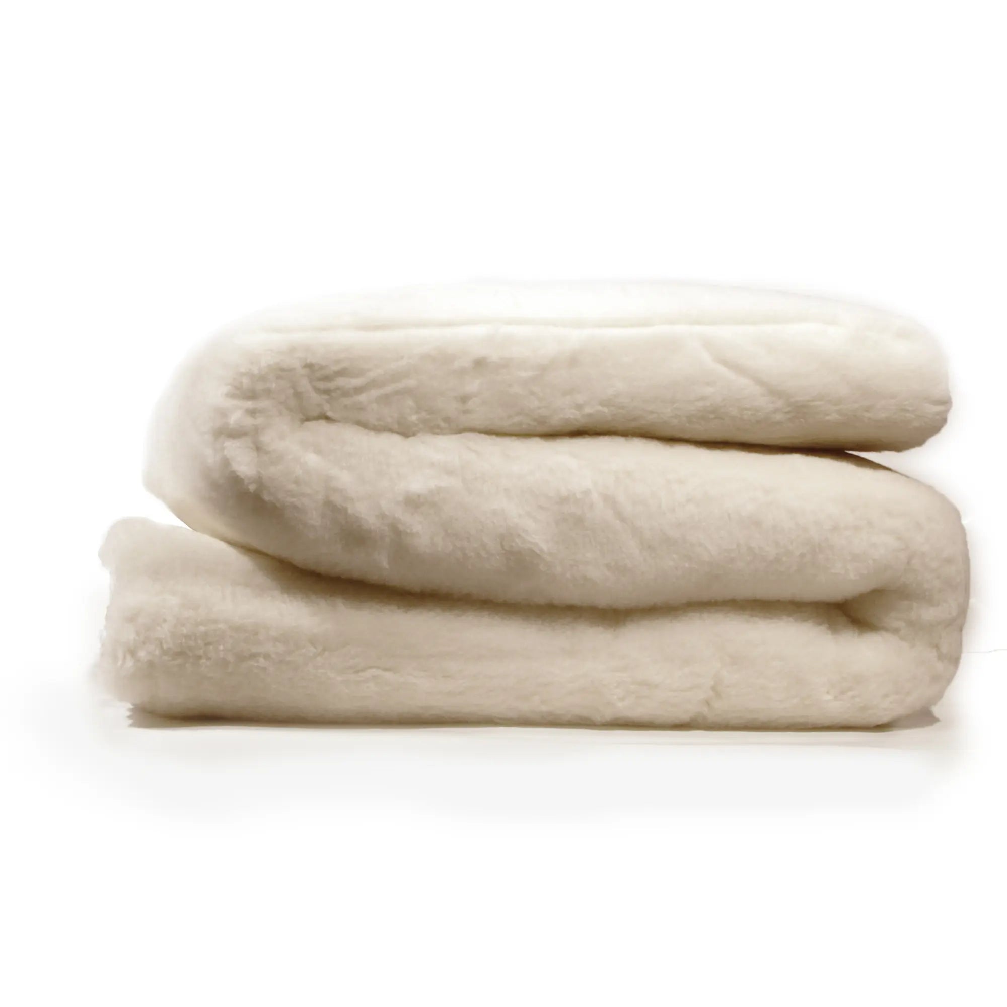 A folded beige futon mattress enhancer with a wool and cashmere top layer. brand name Texeler 