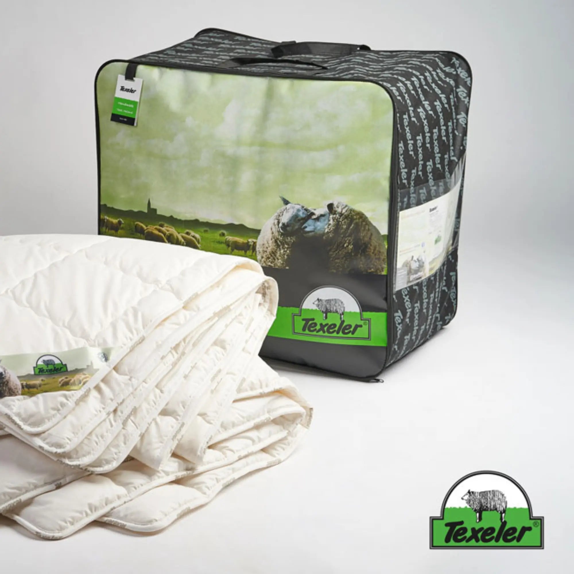 the two layers of the texeler pure nature perkal wool comforter with cotton cover laid on top of eachother with the label clearly visible. With the product bag in the background